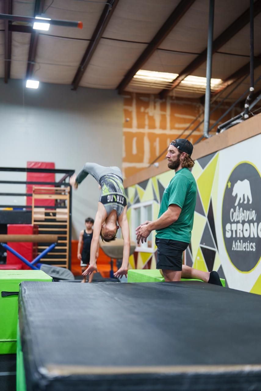 Coach spotting handstand